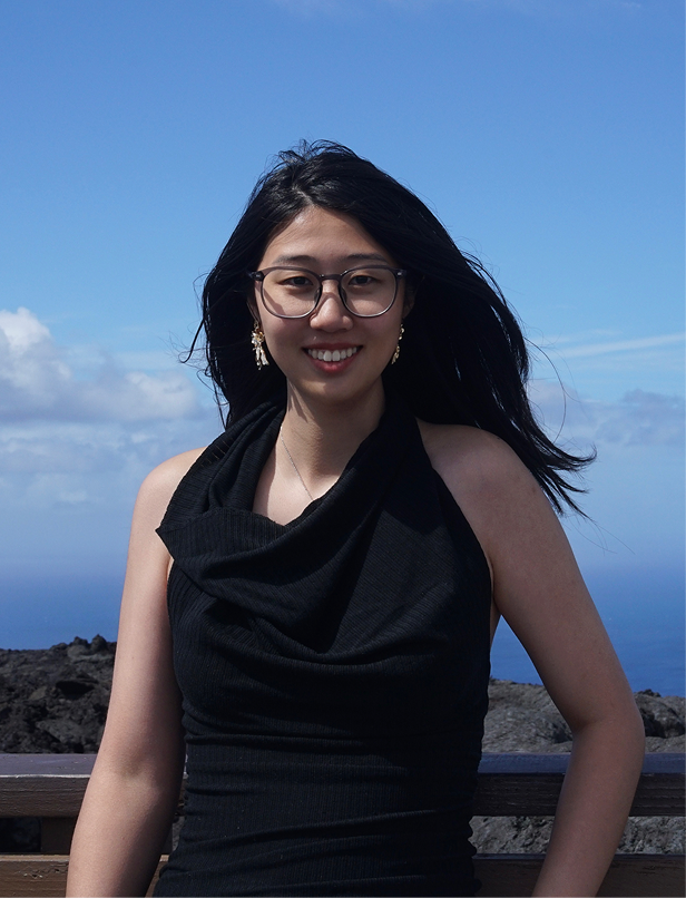 Portrait of Yilin Chen outdoors under a blue sky